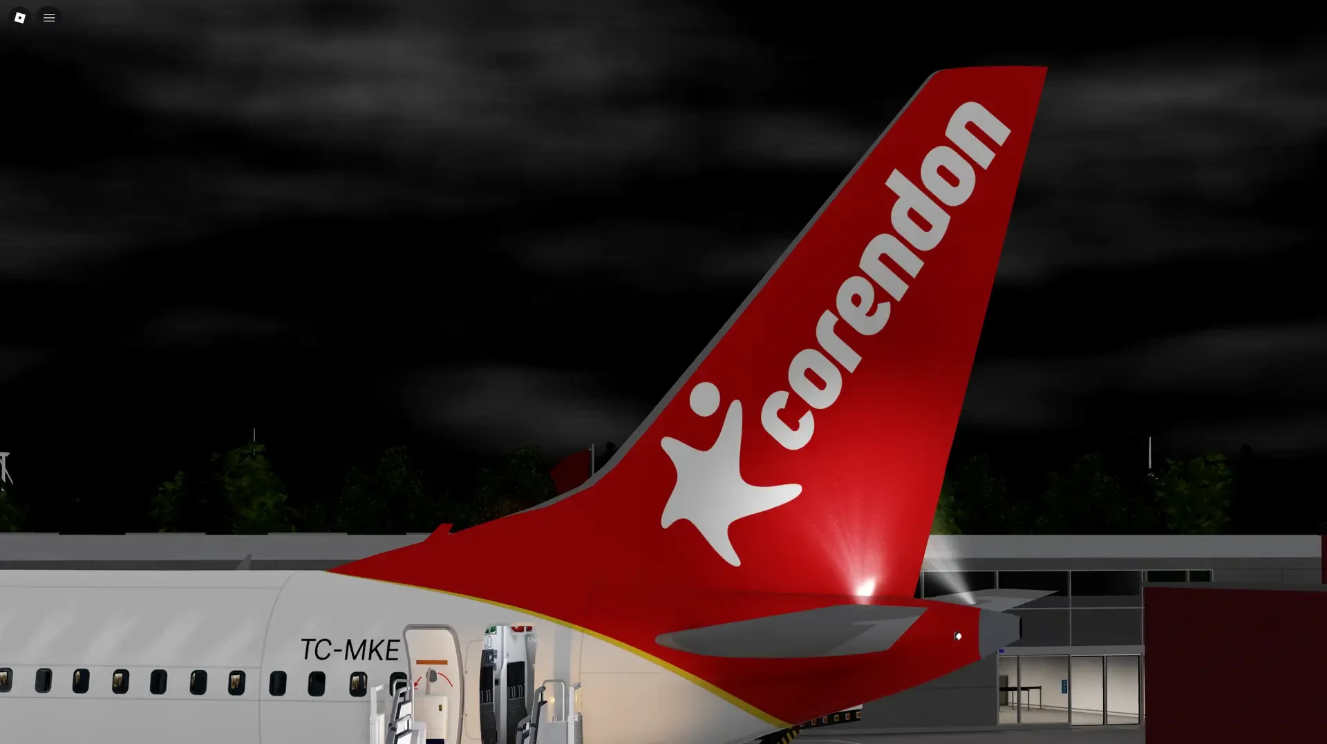 The illuminated red Corendon tail at the airport